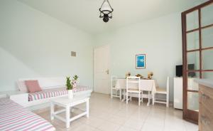 a living room with a couch and a table at Alexandra Apartments in Stalida