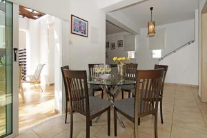 a dining room with a glass table and chairs at Villa Danata in Protaras