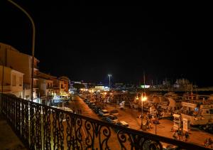 a view of a marina at night with cars parked at Ad Oriente in La Maddalena