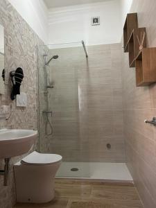 a bathroom with a shower and a toilet and a sink at Villa Mimina in San Pietro in Bevagna
