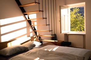 a bedroom with a bed and a window at Kotič na hribu in Dobravlje