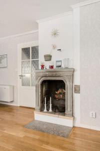 a living room with a fireplace in the corner at Visby city Apartments in Visby