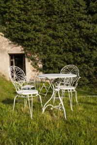 a table and two chairs sitting in the grass at Kotič na hribu in Dobravlje