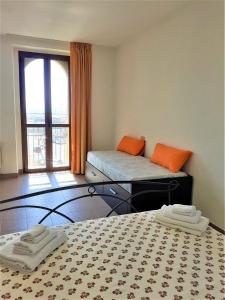 a room with two beds and a large window at K&K Room Duomo1 in Termoli