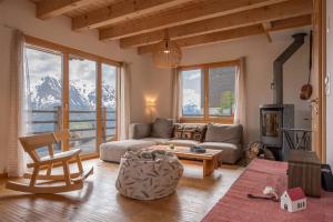 a living room with a couch and a table at Papillon in Bettmeralp