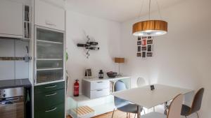 a kitchen with a table and chairs in a room at Bune in Fiesch