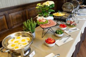 a buffet with eggs and other food on a table at Kamelot in Ternopil
