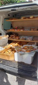 a table of bread and pastries in the back of a car at North Evia Kiki's house in Kourkouloí