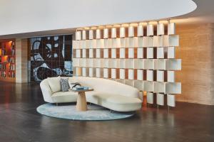 a living room with a white couch and a table at The Maybourne Riviera in Roquebrune-Cap-Martin