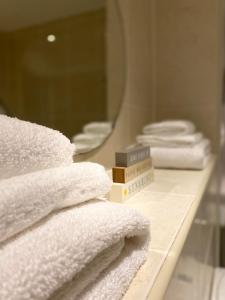 a pile of towels on a counter in a bathroom at St James’ Blvd Newcastle Apartment in Newcastle upon Tyne