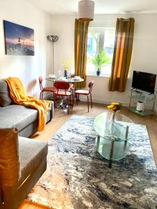 a living room with a couch and a table at St James’ Blvd Newcastle Apartment in Newcastle upon Tyne