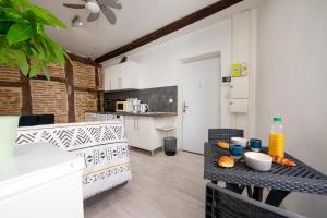 a kitchen with a table with food on it at Le Cocon Castrais in Castres