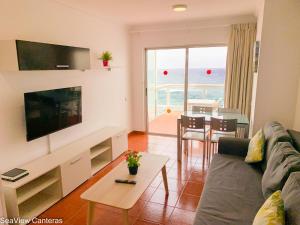 a living room with a couch and a table at Seaview Canteras in Las Palmas de Gran Canaria