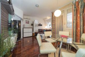a living room with a glass table and chairs at Nana in Pirot