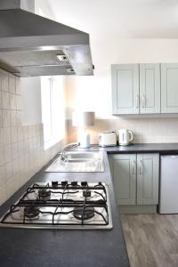 a kitchen with a stove and a sink at 2 Bedroom Apartment in Gateshead in Gateshead