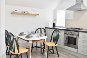 a kitchen with a table and chairs and a stove at 2 Bedroom Apartment in Gateshead in Gateshead