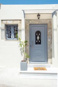 a blue door on a house with a potted plant at Solomon Premium House in Kritsa