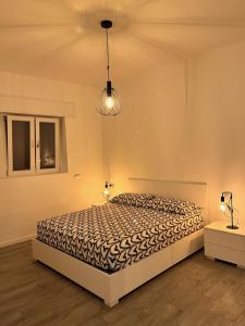 a bedroom with a bed and two lamps and a ceiling at Emma House in Bellano