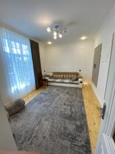 a living room with a couch and a window at Dream House Oguz in Oğuz