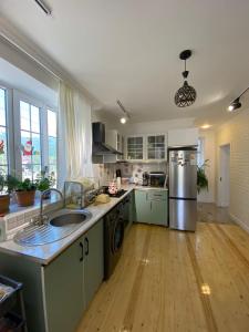 a kitchen with a sink and a refrigerator at Dream House Oguz in Oğuz