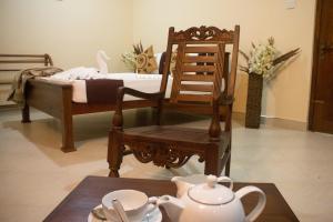 a room with a bed and a chair and a table at Hotel Mount Valley & Yala Safari in Tissamaharama +22 photos