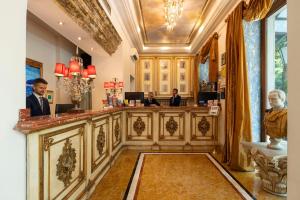 a bar in a hotel with people sitting at a counter at Romanico Palace Luxury Hotel & SPA in Rome