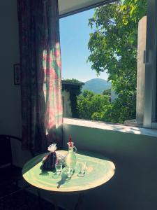 a table in front of a window with wine glasses at Traditional Rooms Elena in Astirákion