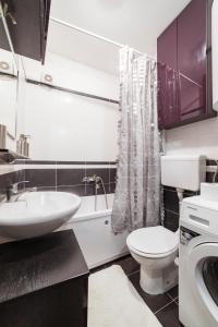 a white bathroom with a sink and a toilet at Nana in Pirot