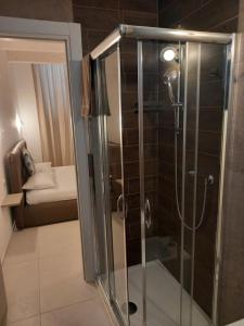 a shower with a glass door in a bathroom at Dimora50 in Porto Recanati