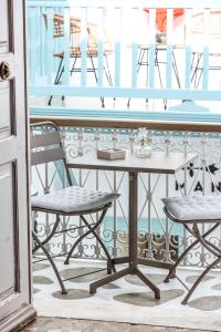 a table and two chairs on a balcony at SIKATE Hospitality in Mikonos +39 photos