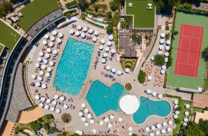 uma vista superior de uma piscina com mesas e guarda-sóis em Olympic Palace Hotel em Ixia