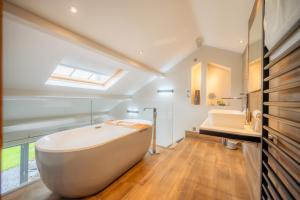 a bathroom with a large white tub and a sink at 1692 Wasdale in Gosforth