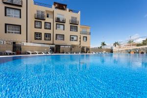 a large swimming pool in front of a building at Oceanfront Rainbow Costa Adeje 14V35 in Callao Salvaje