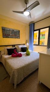 a bedroom with a bed with red shoes on it at Apartamentos Mesa in Valle Gran Rey