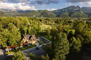an aerial view of a house with mountains in the background at Villa T Apartments & SPA in Zakopane