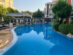 a swimming pool in a hotel with blue water at MESSEMBRIA RESORT in Sunny Beach