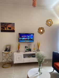 a living room with a tv on a wall at Davkin Apartments in Mombasa