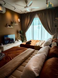 a bedroom with two beds and a large window at Teega Suites By JettBros Johor Bahru in Nusajaya +42 photos