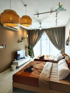 a bedroom with two beds and a large window at Teega Suites By JettBros Johor Bahru in Nusajaya