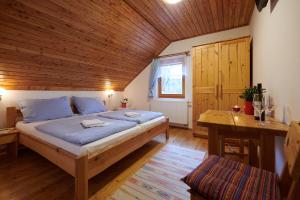 a bedroom with a bed and a wooden ceiling at Penzion U Strakatého Koně in Blansko