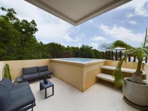 a patio with a swimming pool and a patio furniture at Casa Kuaan Mani TH 1 in Tulum