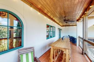 a dining room with a wooden table and windows at Abruzzi - Villa C in Eatonton 