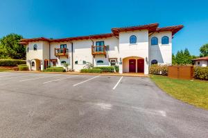 a large white building with a parking lot at Abruzzi - Villa C in Eatonton 