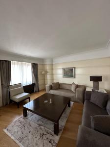 a living room with a couch and a coffee table at Surmeli Istanbul Hotel in Istanbul