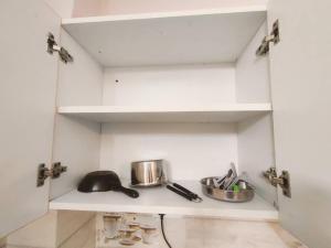 a kitchen with white cabinets and a sink at RJ Homestay in Dehradun