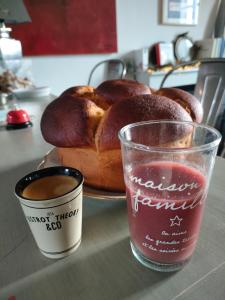 a table with a plate of bread and a cup of coffee at L' Embellie sur Lot in Sainte-Livrade-sur-Lot