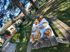 a picnic table with a plate of food on it at L' Embellie sur Lot in Sainte-Livrade-sur-Lot
