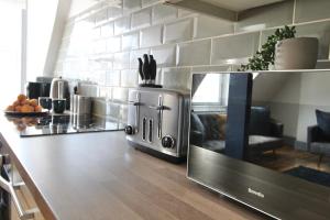 a kitchen with a counter top with a microwave at Magnificent One Bed Penthouse in Nottingham