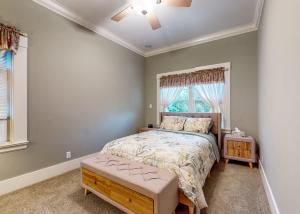 a bedroom with a bed and a window at Forbestown Carriage House in Lakeport