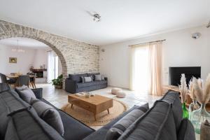 a living room with a couch and a table at Sun and Salt 3bedroom House in Aliki